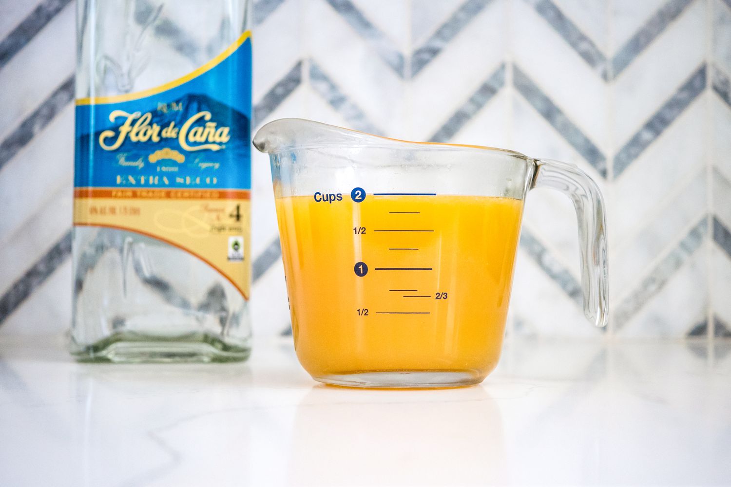 Peach Puree Next to Bottle of Rum for Peach Daiquiri Popsicles