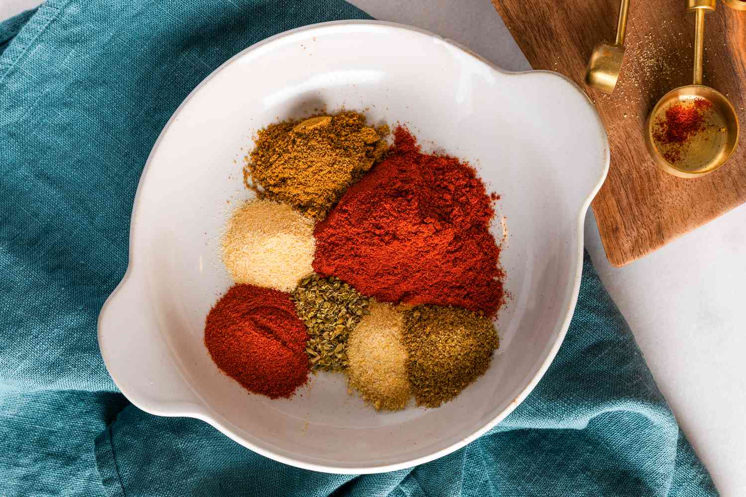 Bowl of different spices for homemade chili powder recipe