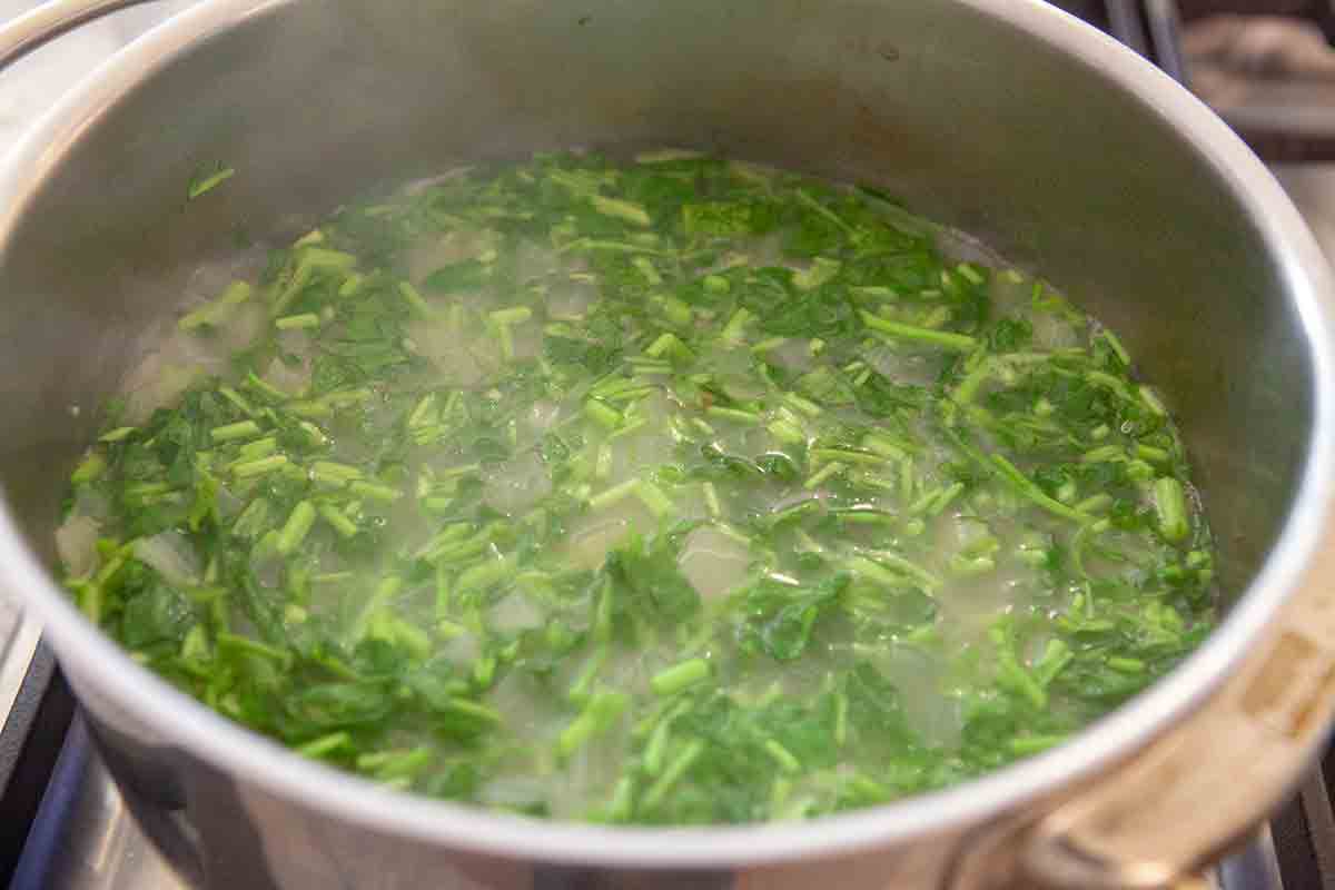 add chopped watercress to soup in pot