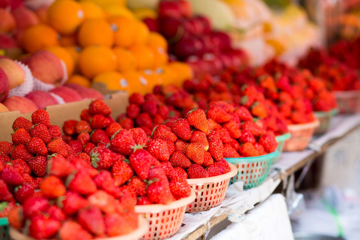 baskets filled with strawberries on a store shelf