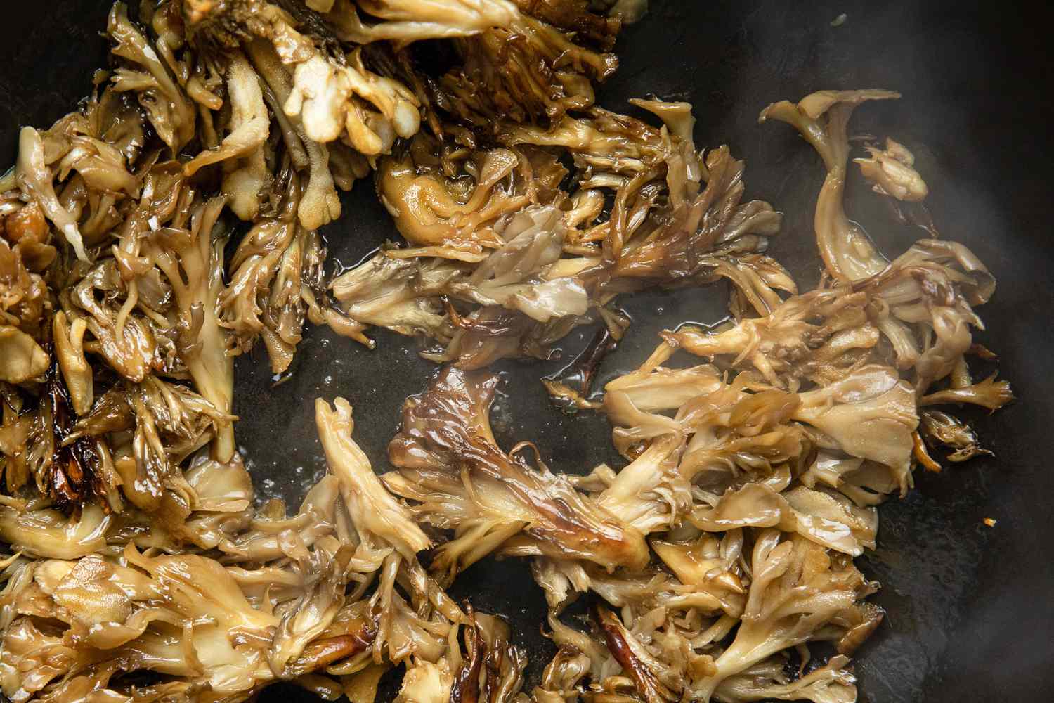 Soy Sauce Added to Stir-Fried Maitake Mushrooms with Garlic and Chile Oil