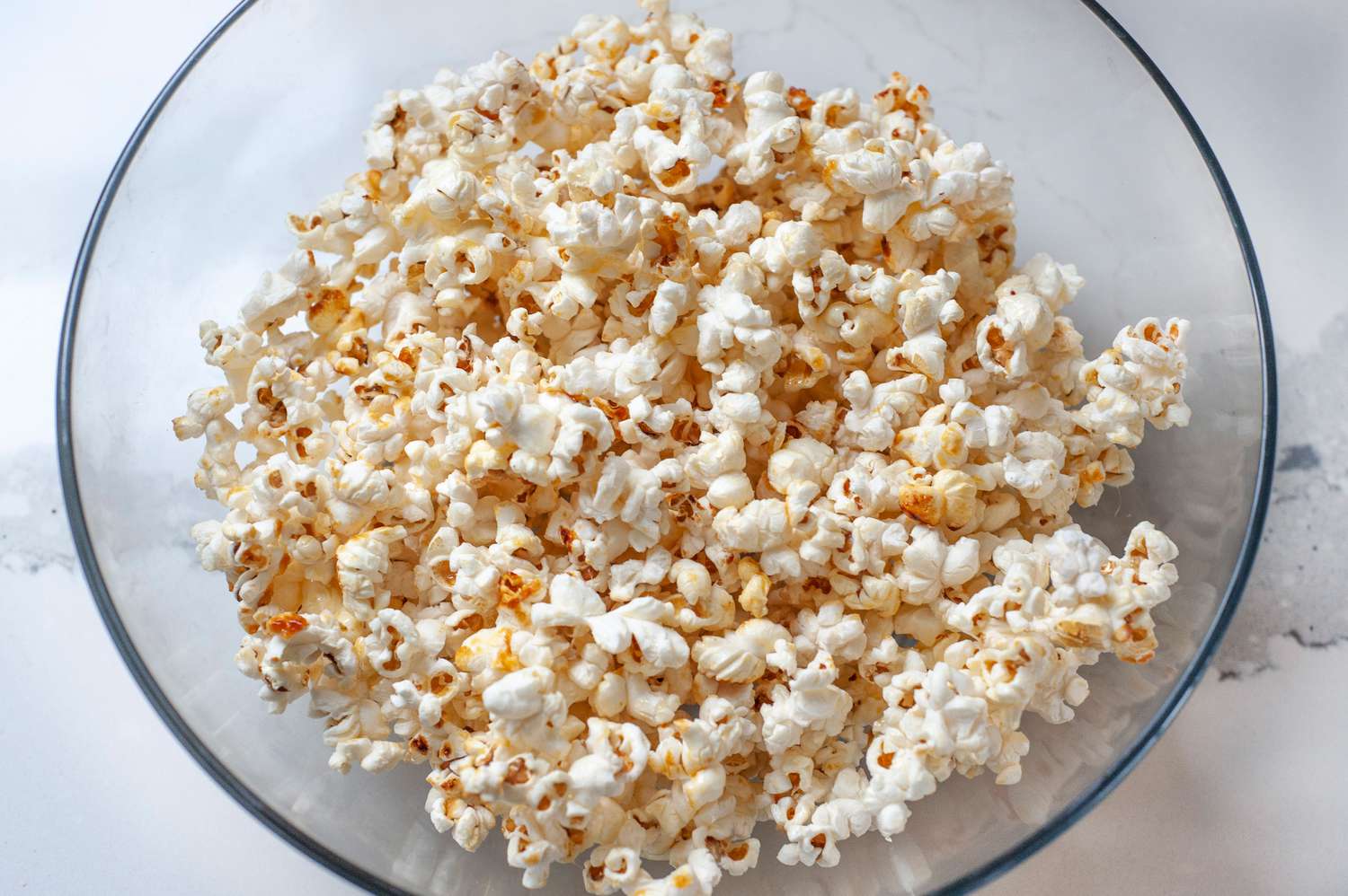 A large glass bowl of kettle popcorn.