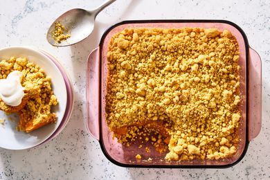 overhead view of a baking dish of 4-Ingredient Sweet Potato Dump Cake, one serving scooped out onto a dessert plate