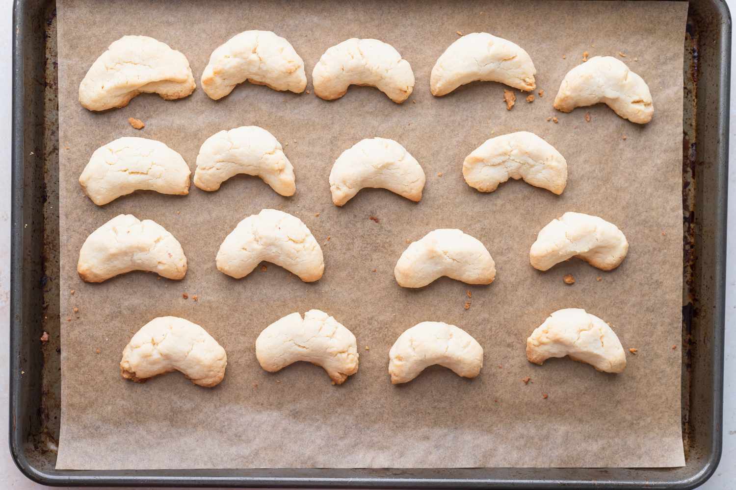 Baked almond flour sugar cookies on a parchment lined baking sheet.