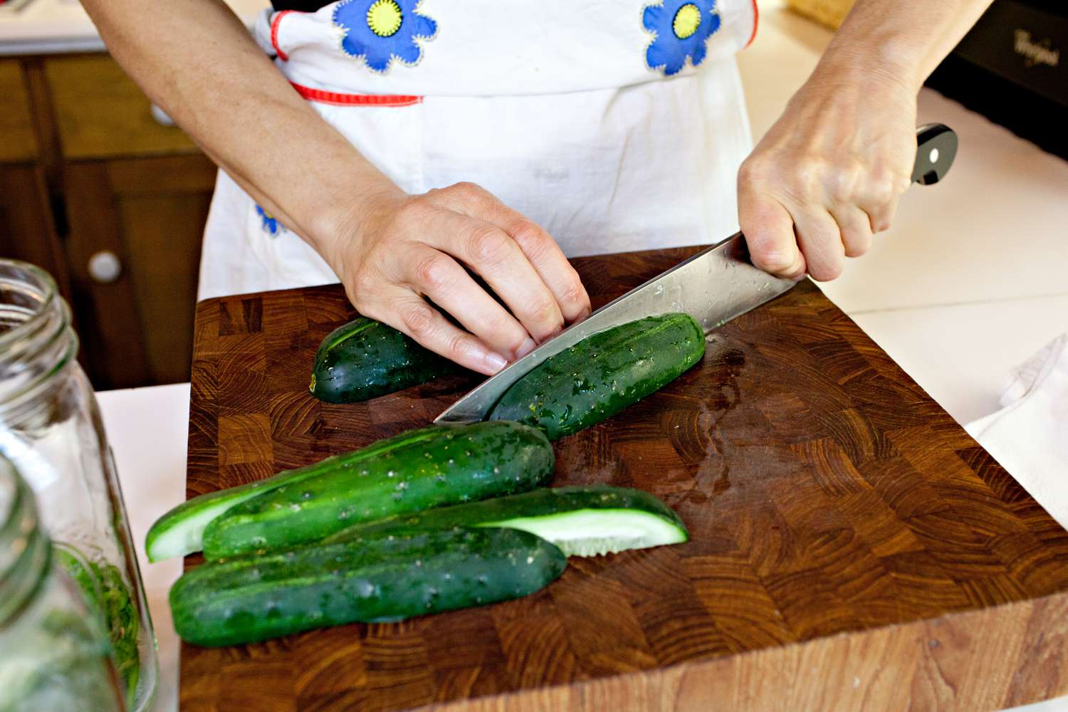 Pickling Cucumbers Cut into Wedges on a Cutting Block Using a Knife for Fermented Pickles Recipe