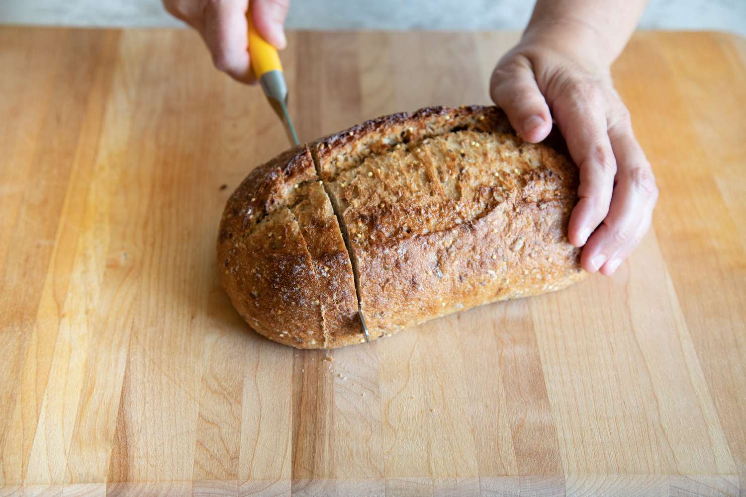 Slicing an artisan loaf of bread