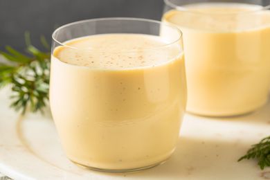 Two glasses of eggnog on a table