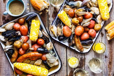 Clambake on platters with dirnks and melted butter on the side