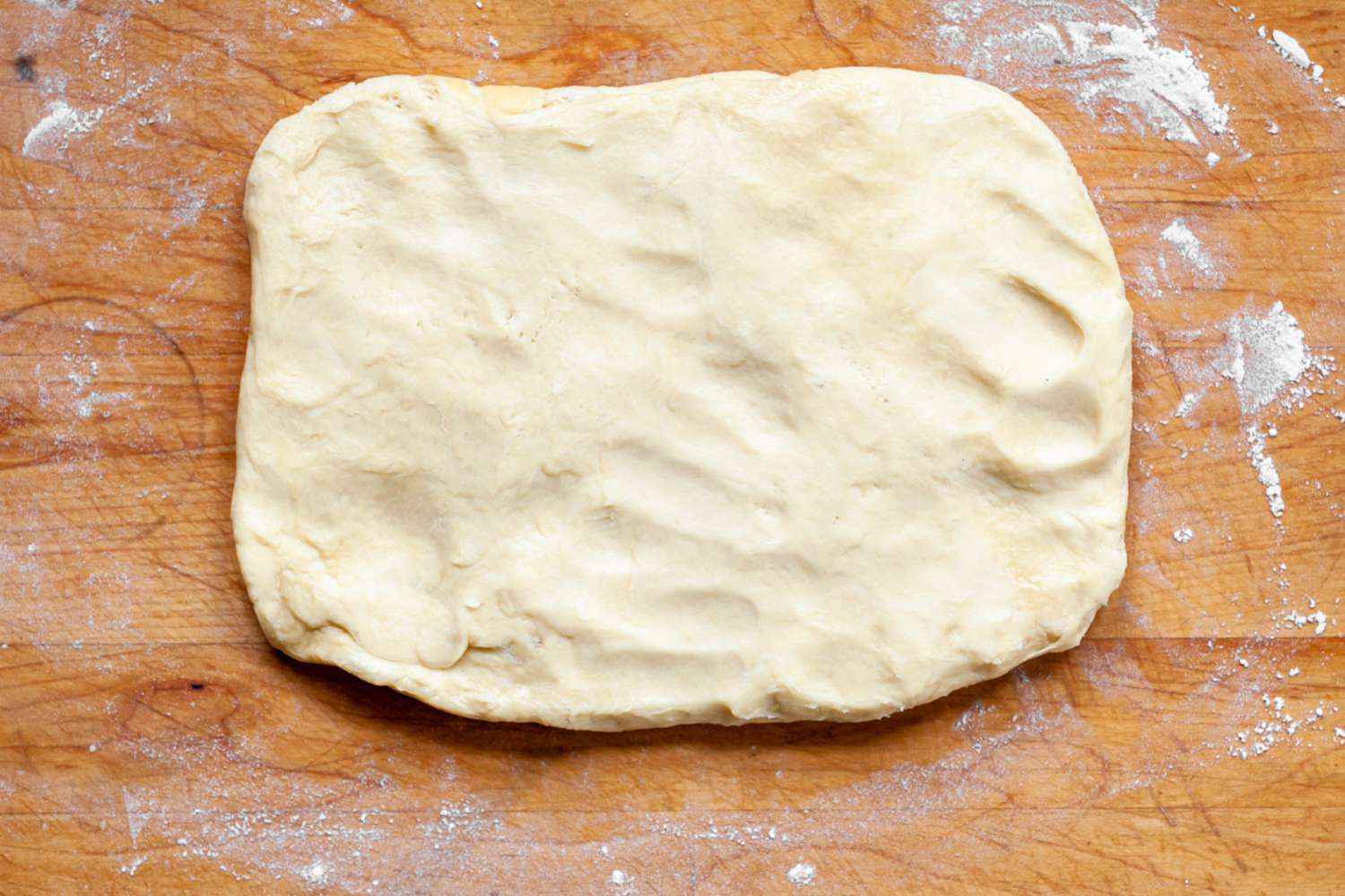 Brioche Sandwich Loaf Dough Rolled Out on a Flour Covered Surface