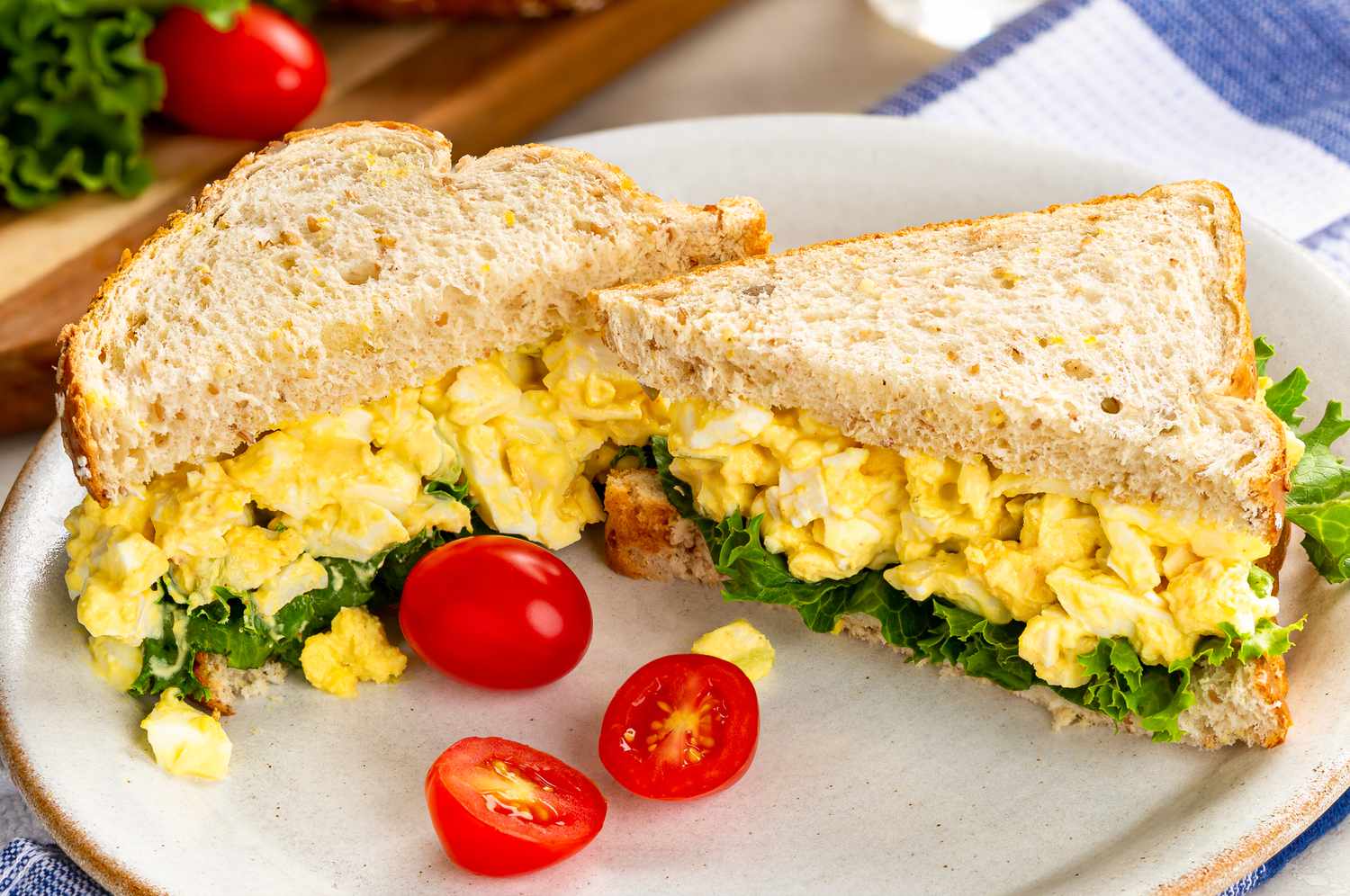 Chicken salad sandwich on a plate with cherry tomatoes