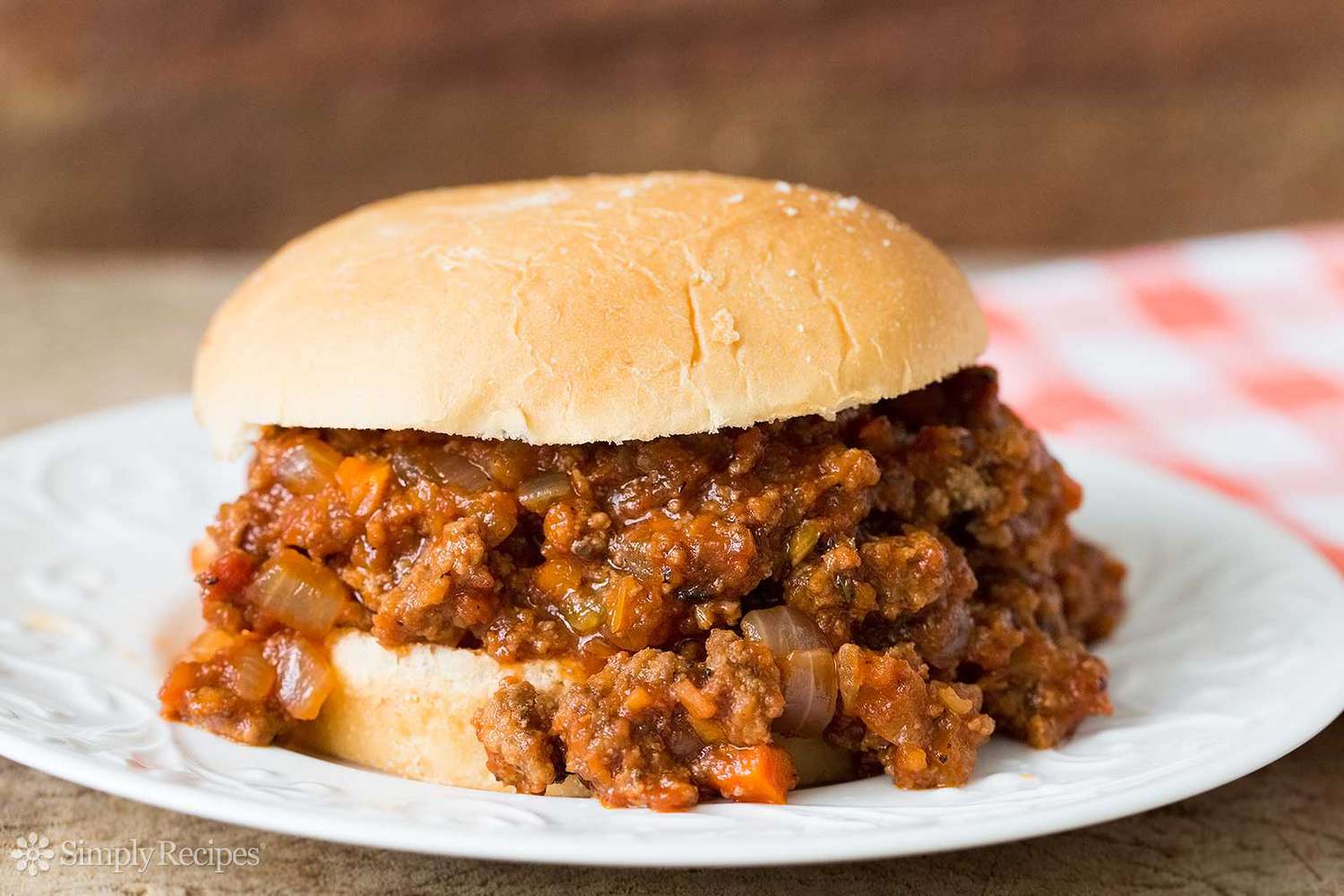 Sloppy Joe Sandwich on a Plate With the Filling Cascading From the Bun