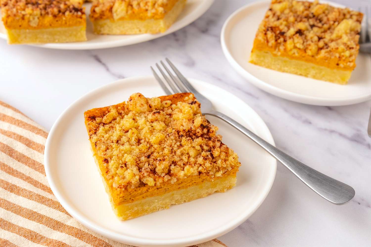 Pumpkin Cream Cheese Bar on a plate with a fork