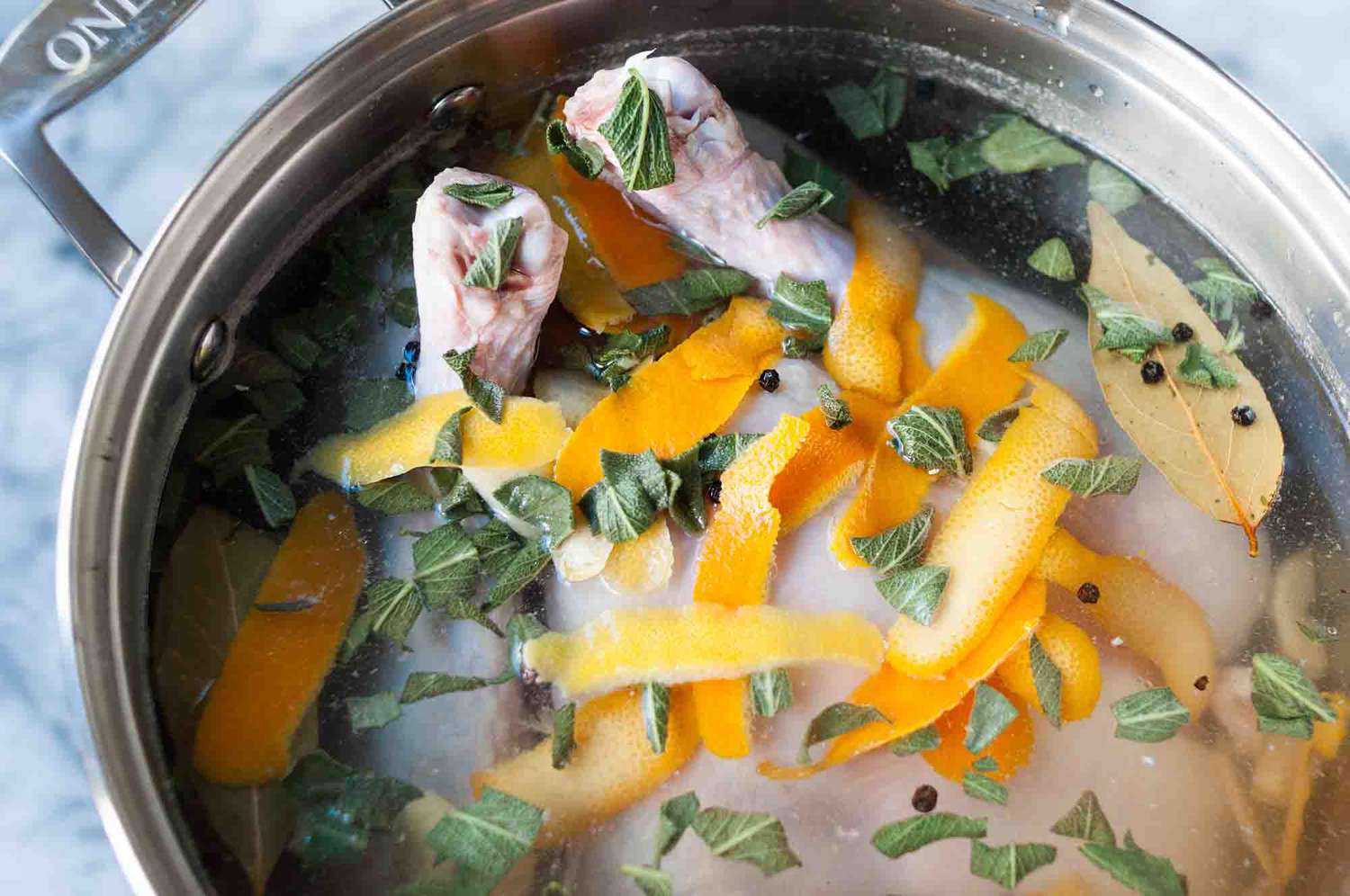 A turkey brining in a pot of water 
