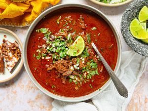 Birria in a bowl garnished with a lime wedge 