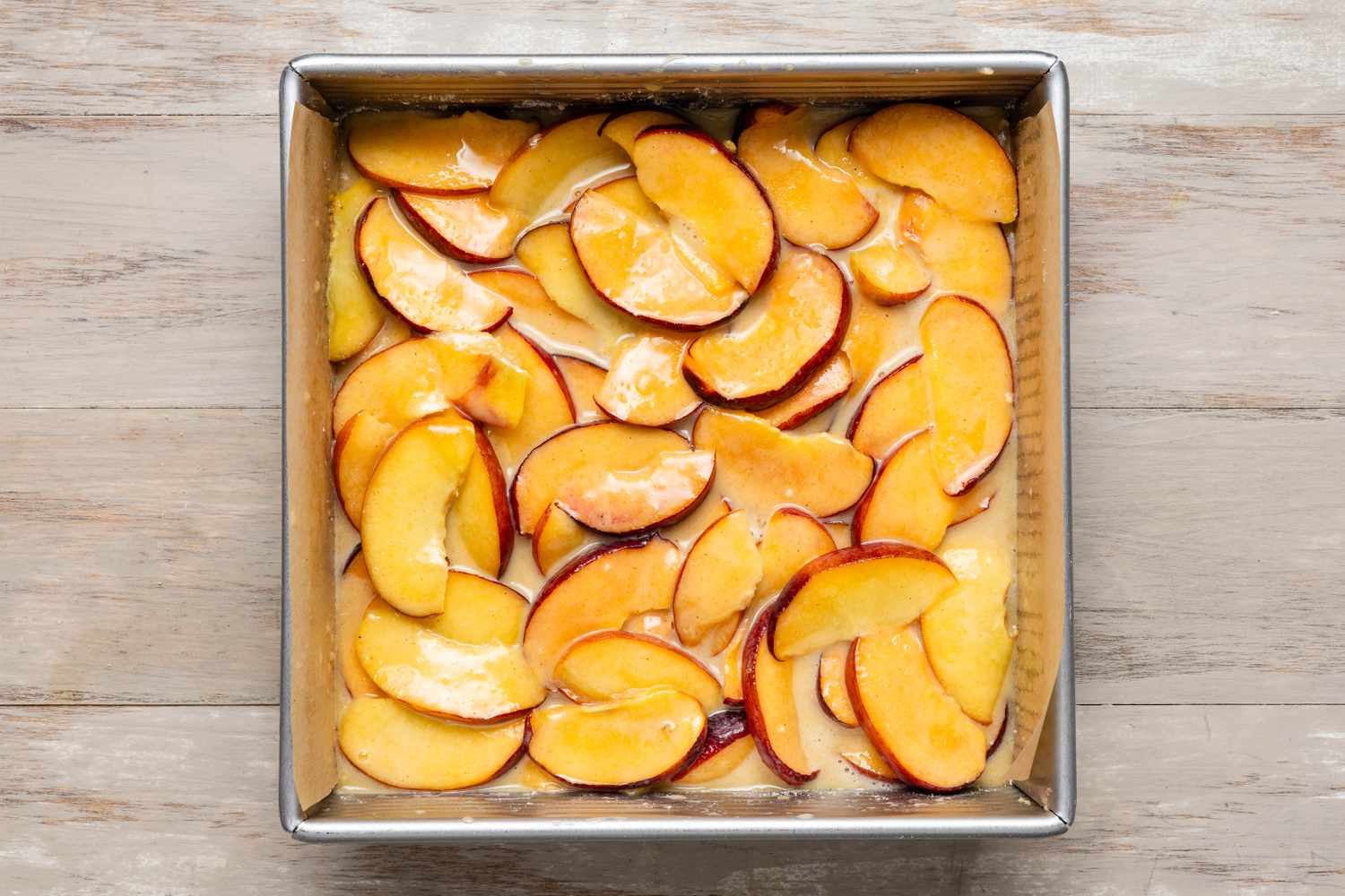 peach pie bar filling on top of the dough in the pan, before baking
