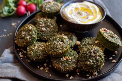Kuku Sabzi on platter with yogurt dip.