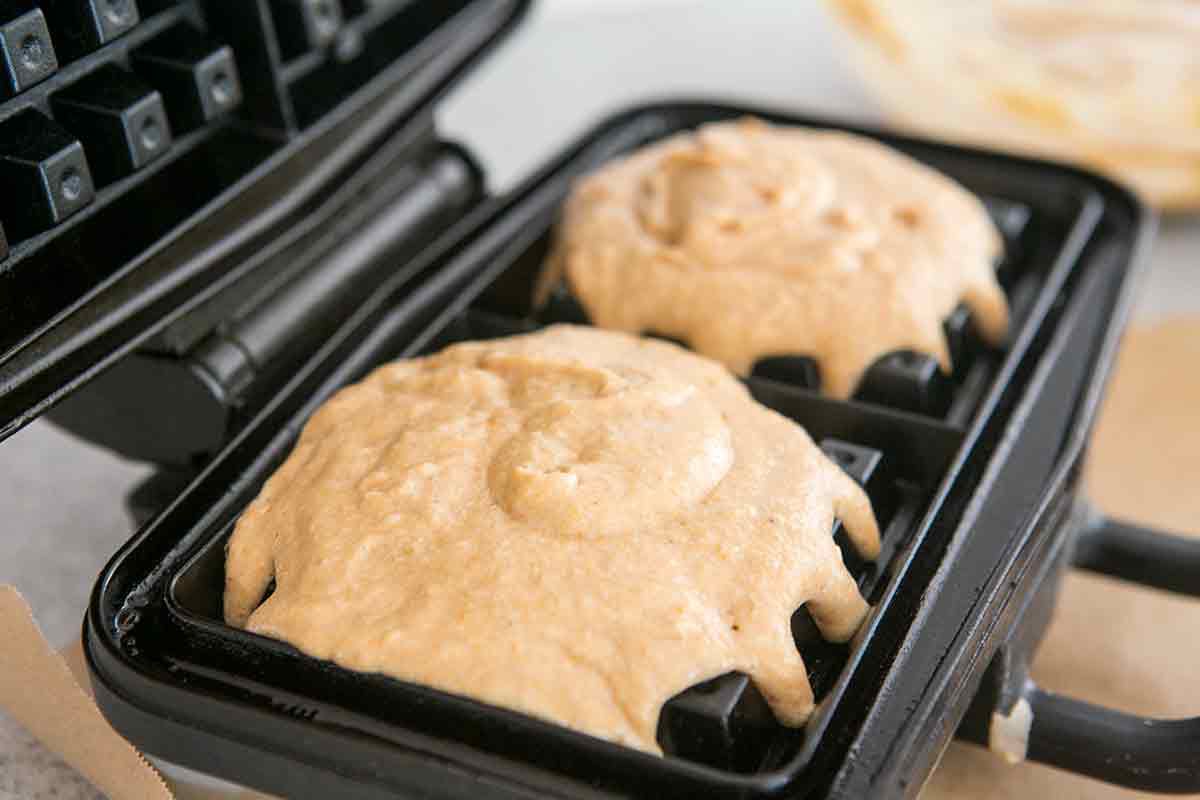 pumpkin waffle mix poured into waffle iron