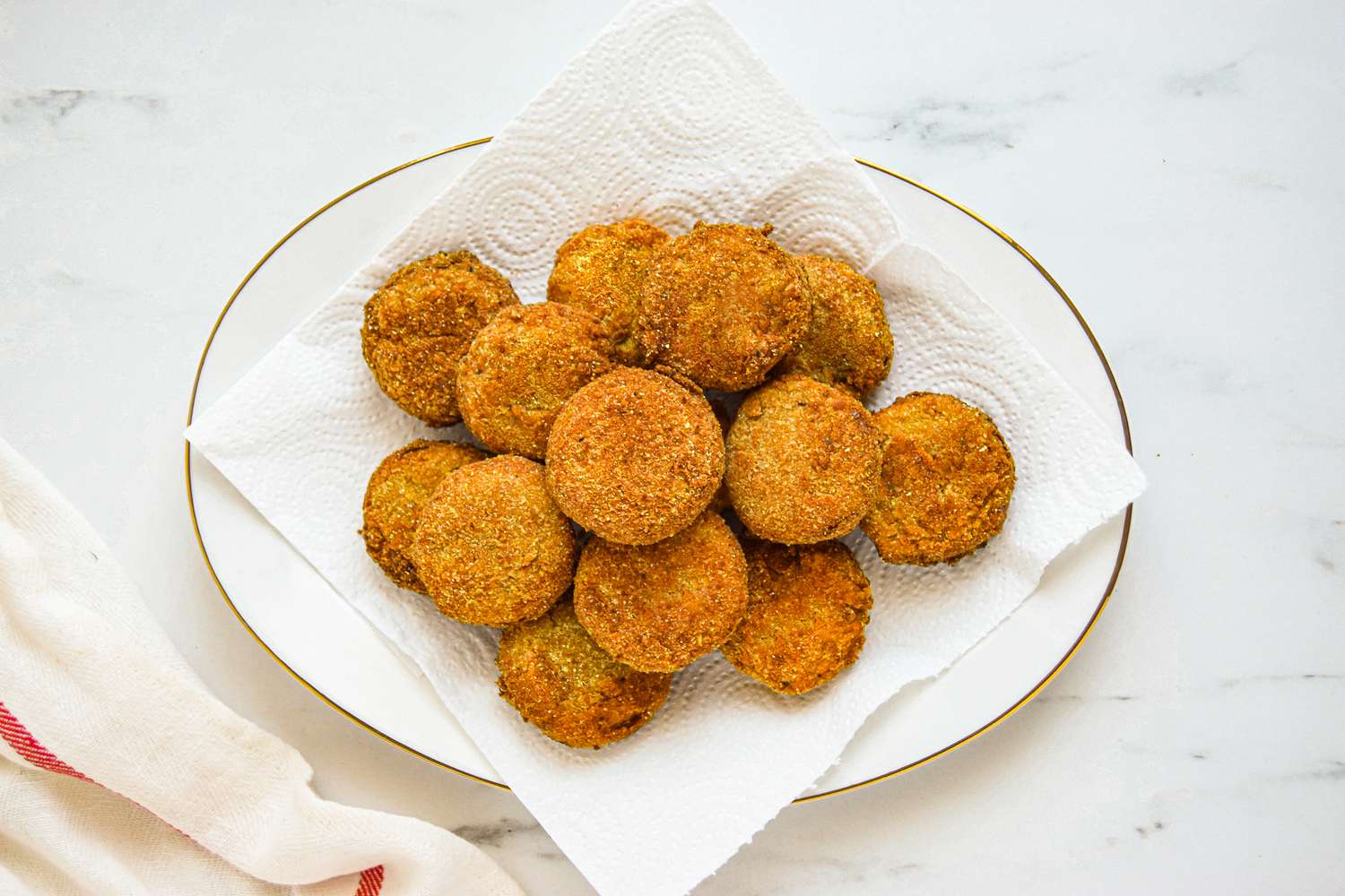 Overhead view of a plate of fried green tomatoes.