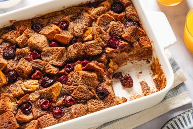 Baked Nutella and cherry French toast in a white dish with some portions missing