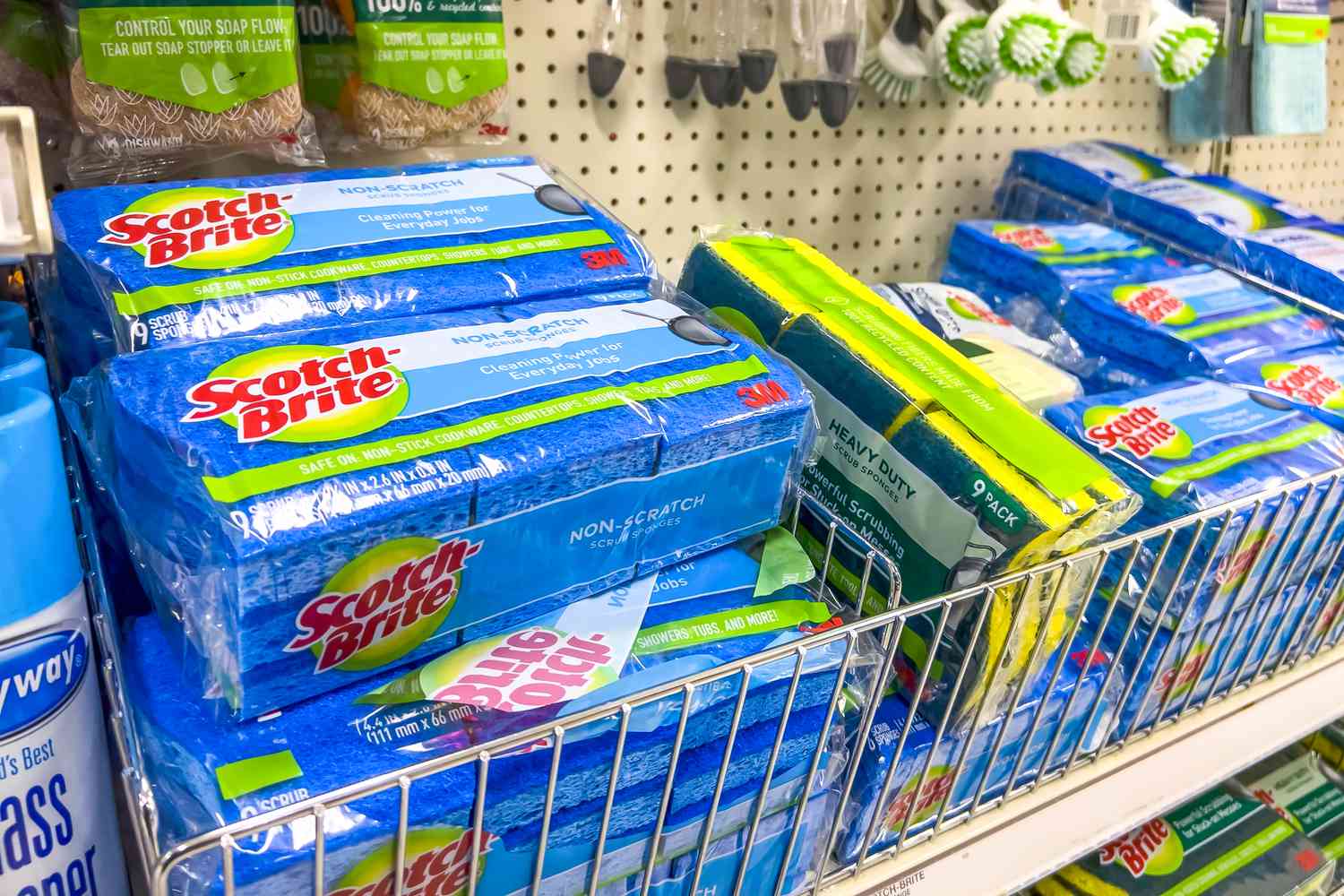 packages of scotch brite sponges and other kitchen cleaning supplies on store shelves 