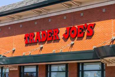 View of the front of a Trader Joe's store and sign on a red brick surface