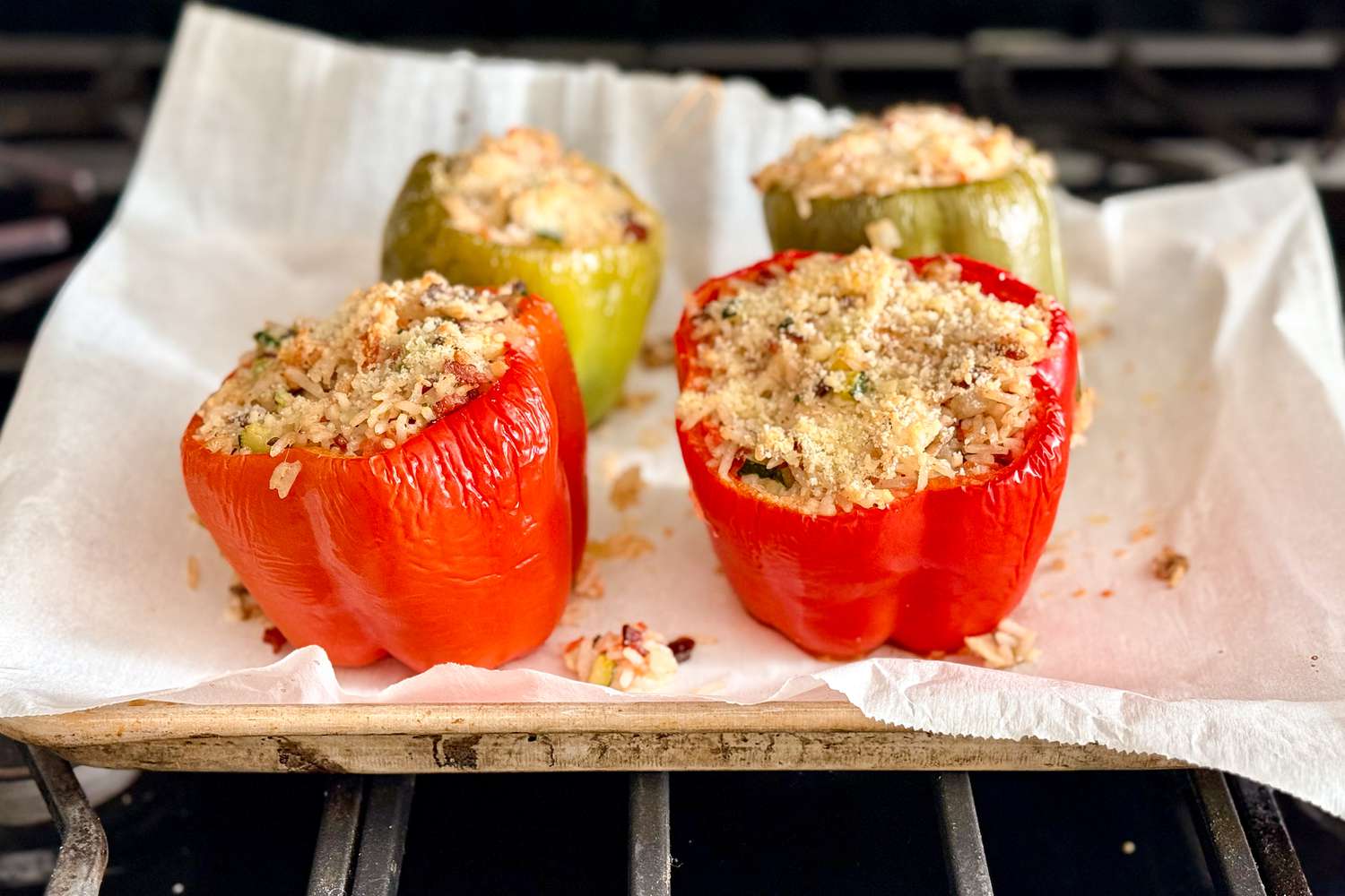 stuffed bell peppers on a cooking sheet with parchment