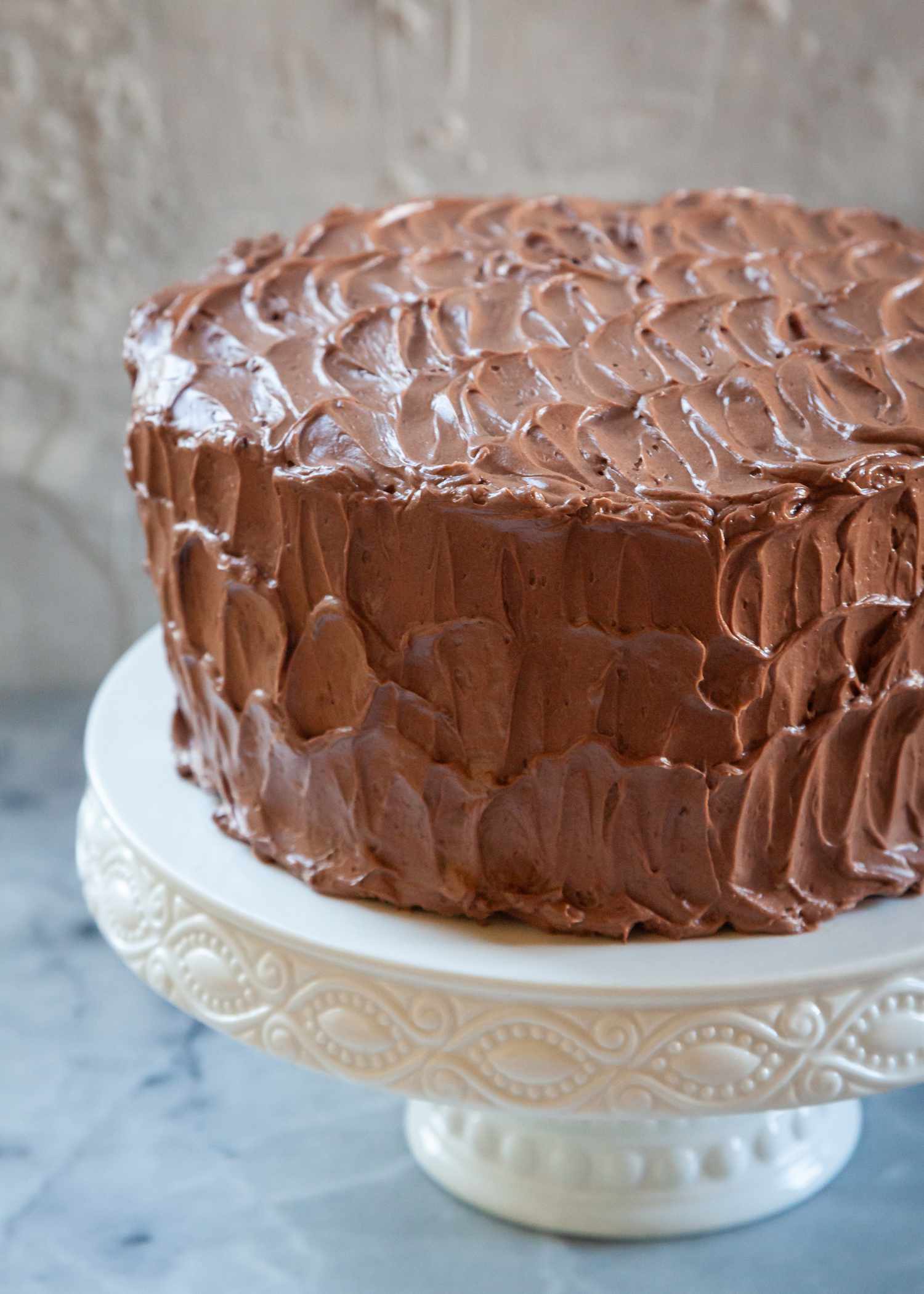 A chocolate cake on a cake stand.