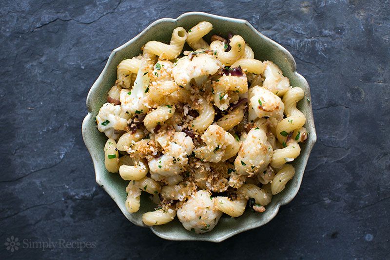 A bowl of pasta with cauliflower and bacon, ready to eat