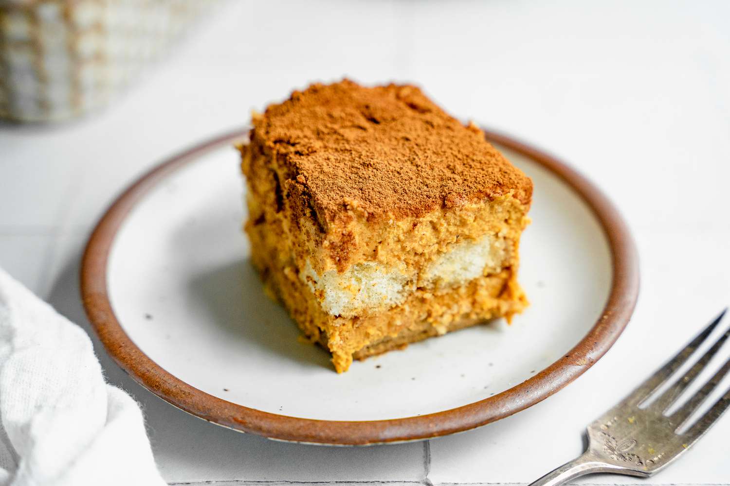 Slice of Pumpkin Tiramisu on a Plate Next to a Fork