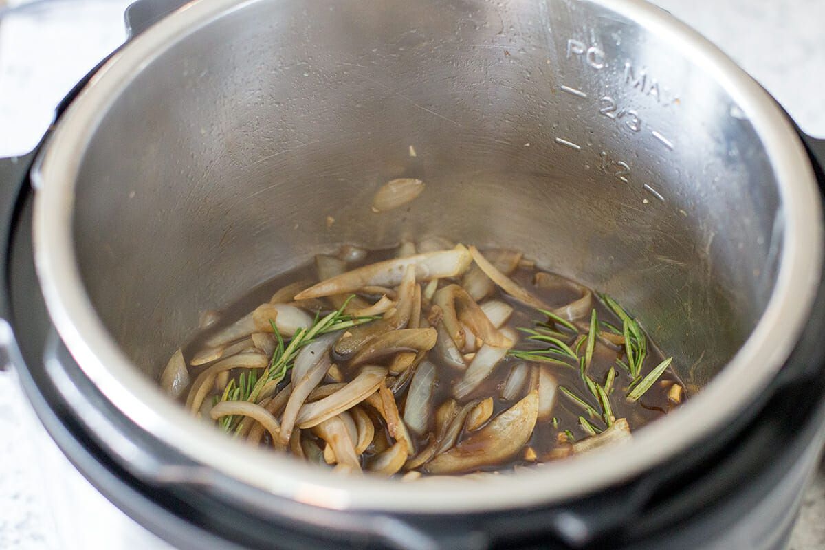 Stir the onions, rosemary, and garlic together with the beef broth and balsamic vinegar for the instant pot roast beef