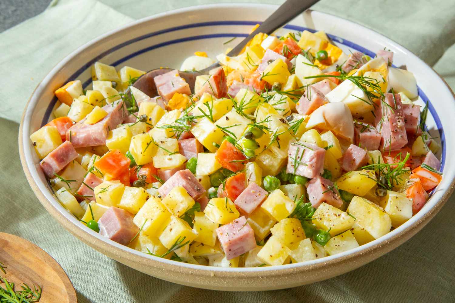bowl of olivier potato salad on a table