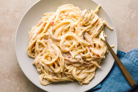 Chicken Queso Spaghetti on a plate with a fork