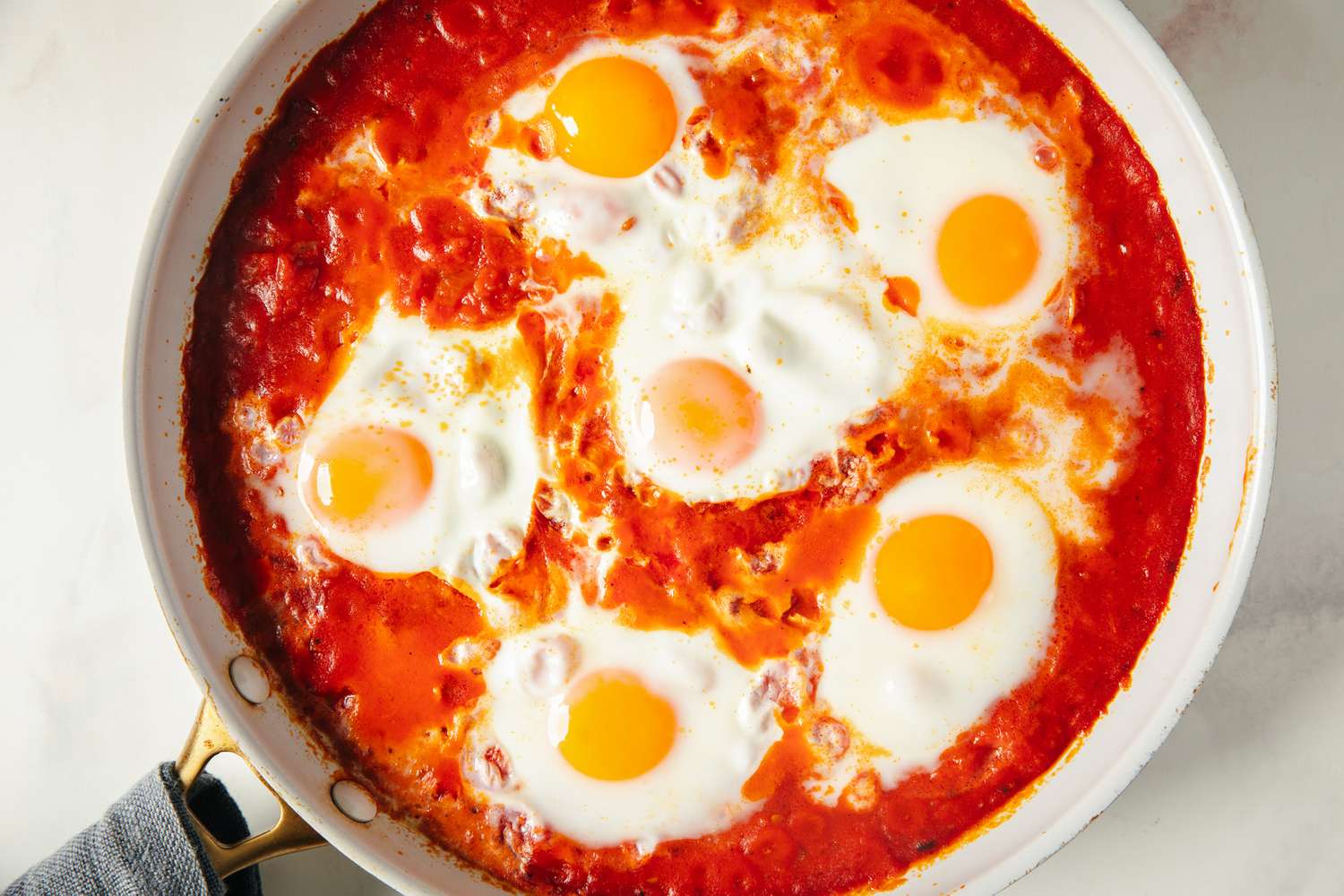 Skillet with eggs cooked in a tomatobased sauce a dish known as eggs in purgatory