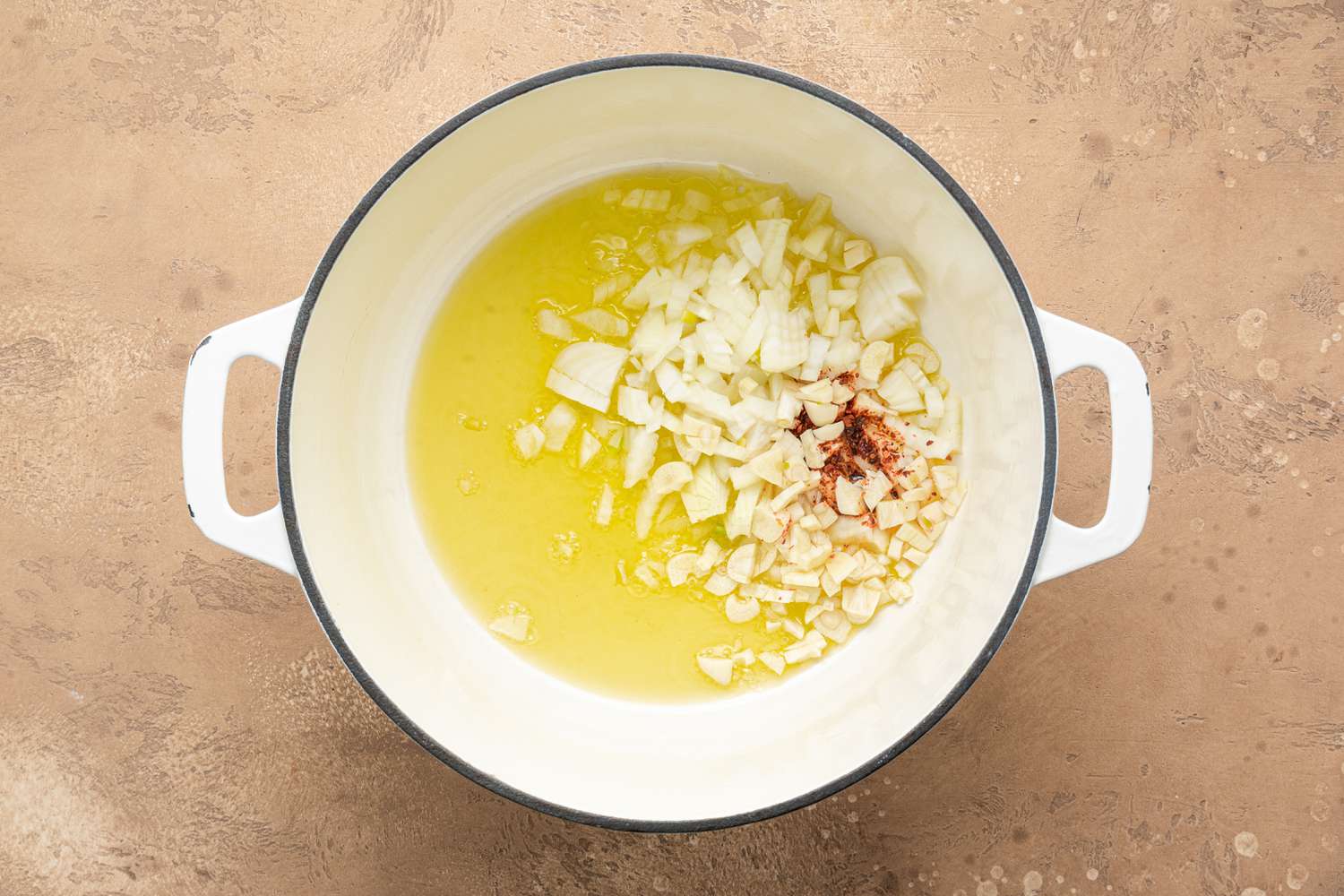 Oil, Onion, Garlic, and Paprika in a Pot for Creamy White Bean Soup with Sage Gremolata Recipe