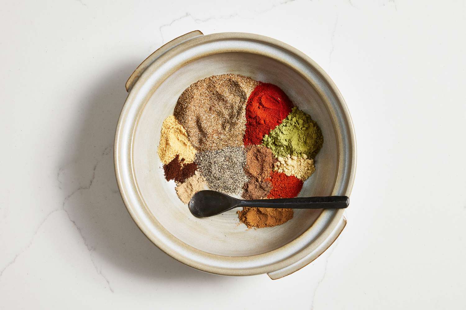 Bowl With Old Bay Ingredients (Not Mixed) With a Spoon