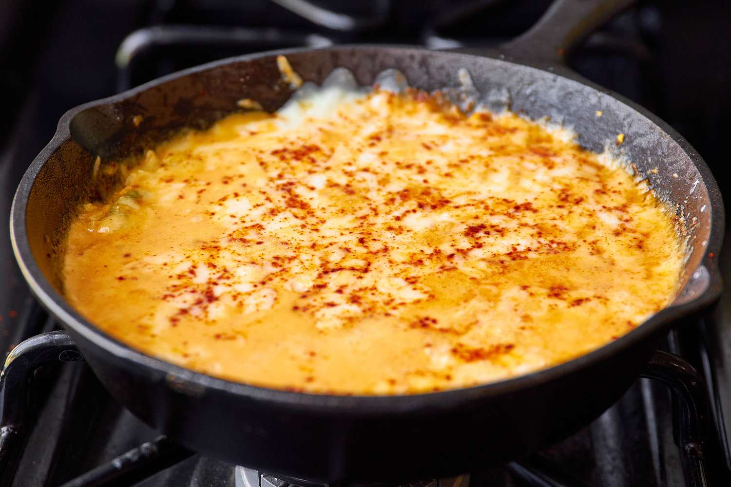Cheese Corn in a Cast Iron Skillet With the Top Layer of Cheese Completely Melted