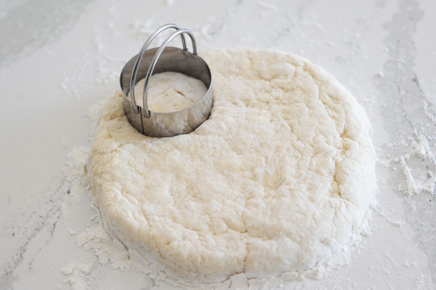 Dough rolled out and cut to make English-Style Scones.