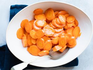 Overhead view of a serving bowl of glazed carrots.