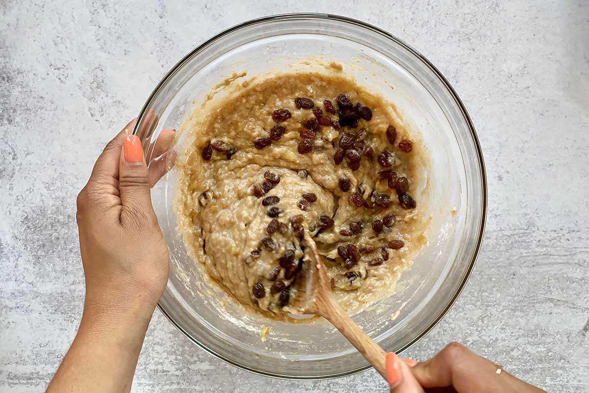 Jamaican Banana Bread batter getting the rum soaked raisins stirred into it.
