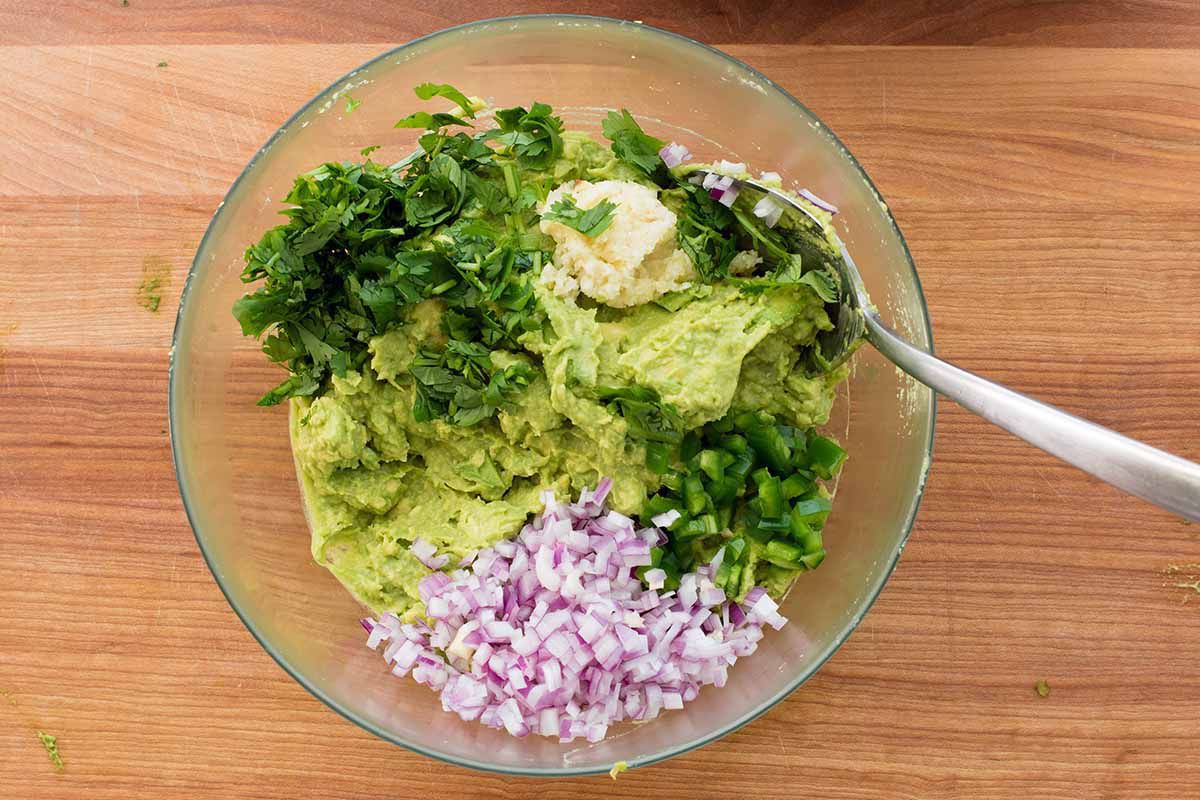 How to Make Chipotle Guacamole - avocado, onion, cilantro in a bowl