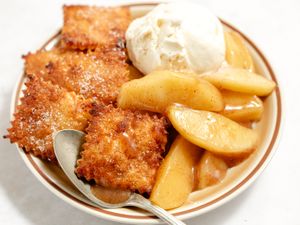 short-cut apple pie in a bowl with a spoon (close-up)