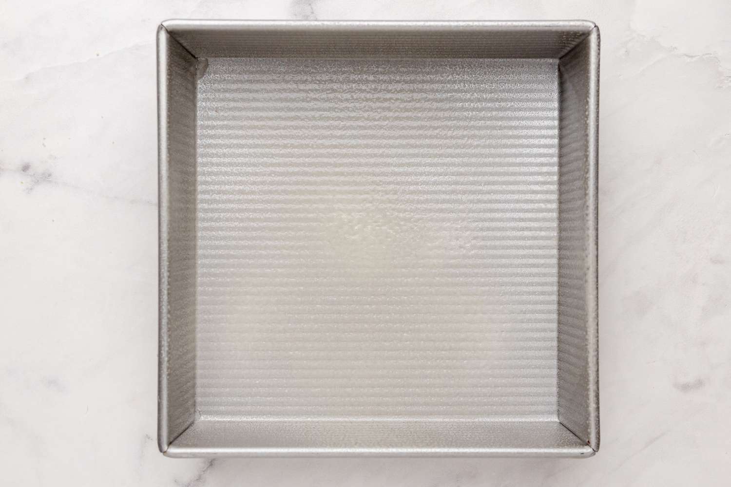 Oil Sprayed onto Baking Pan for S’mores Cereal Bars Recipe