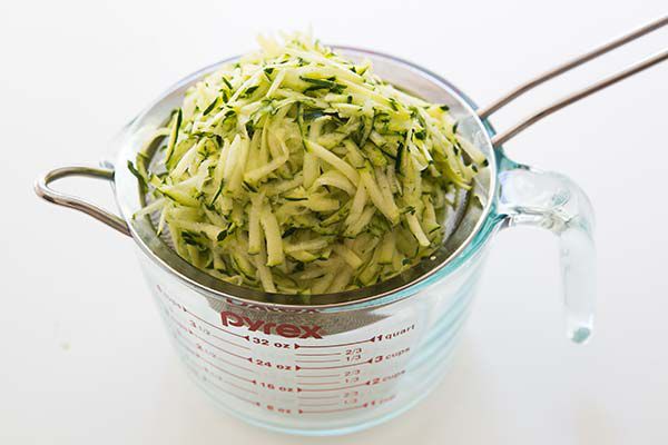 shredded zucchini in sieve