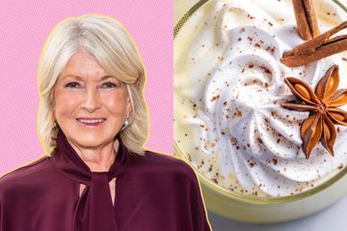 Martha Stewart next to a glass of eggnog topped with whipped cream and spices