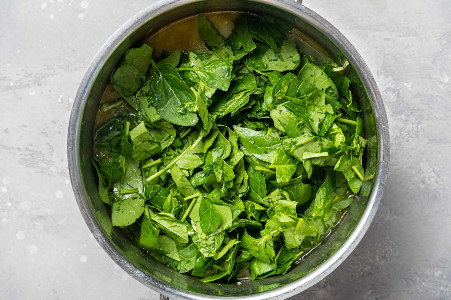 Adding fresh spinach to make a Cream of Spinach Soup recipe