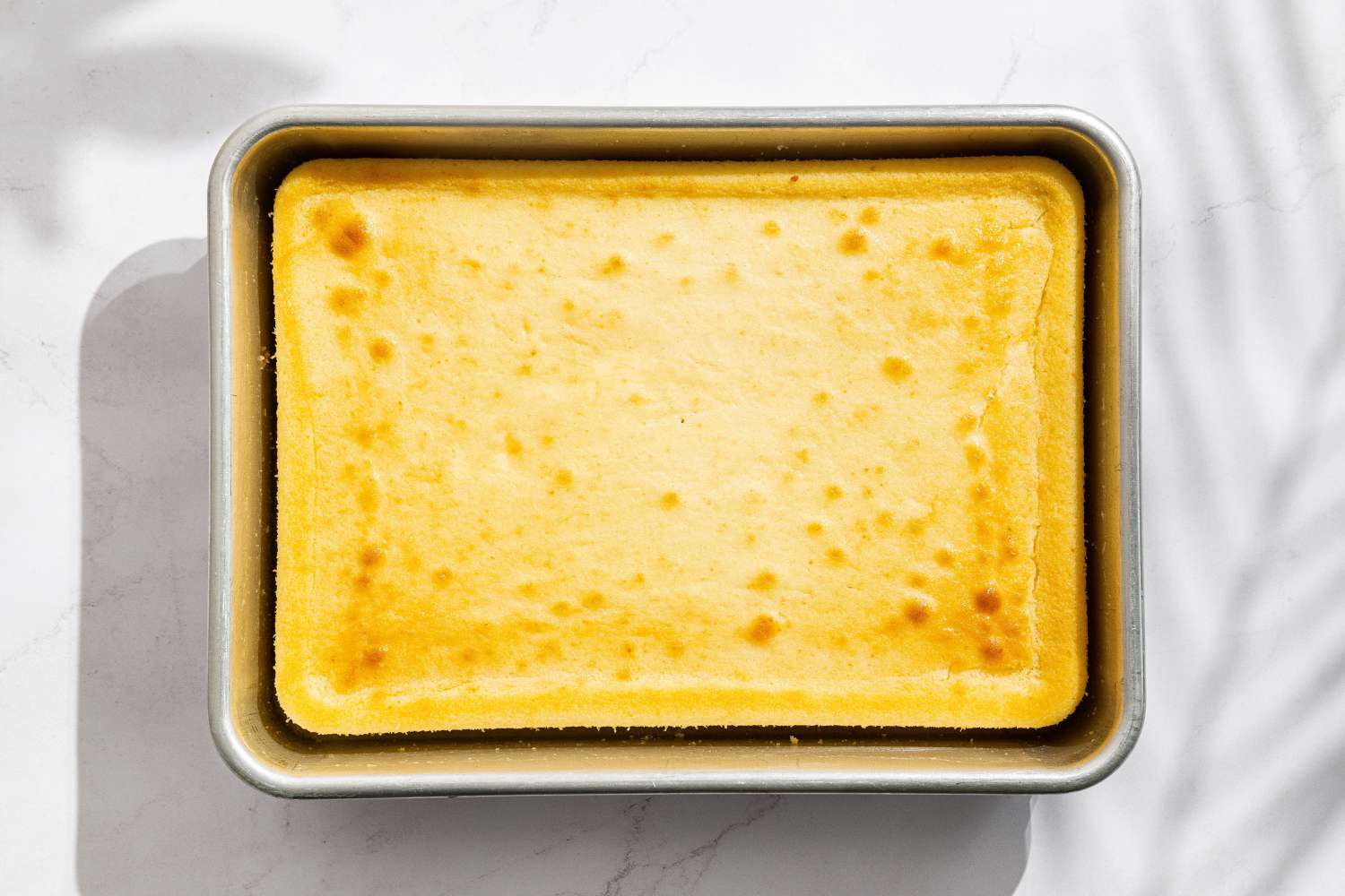 overhead view of cooked cake in tin for Easy Berry Chantilly Cake