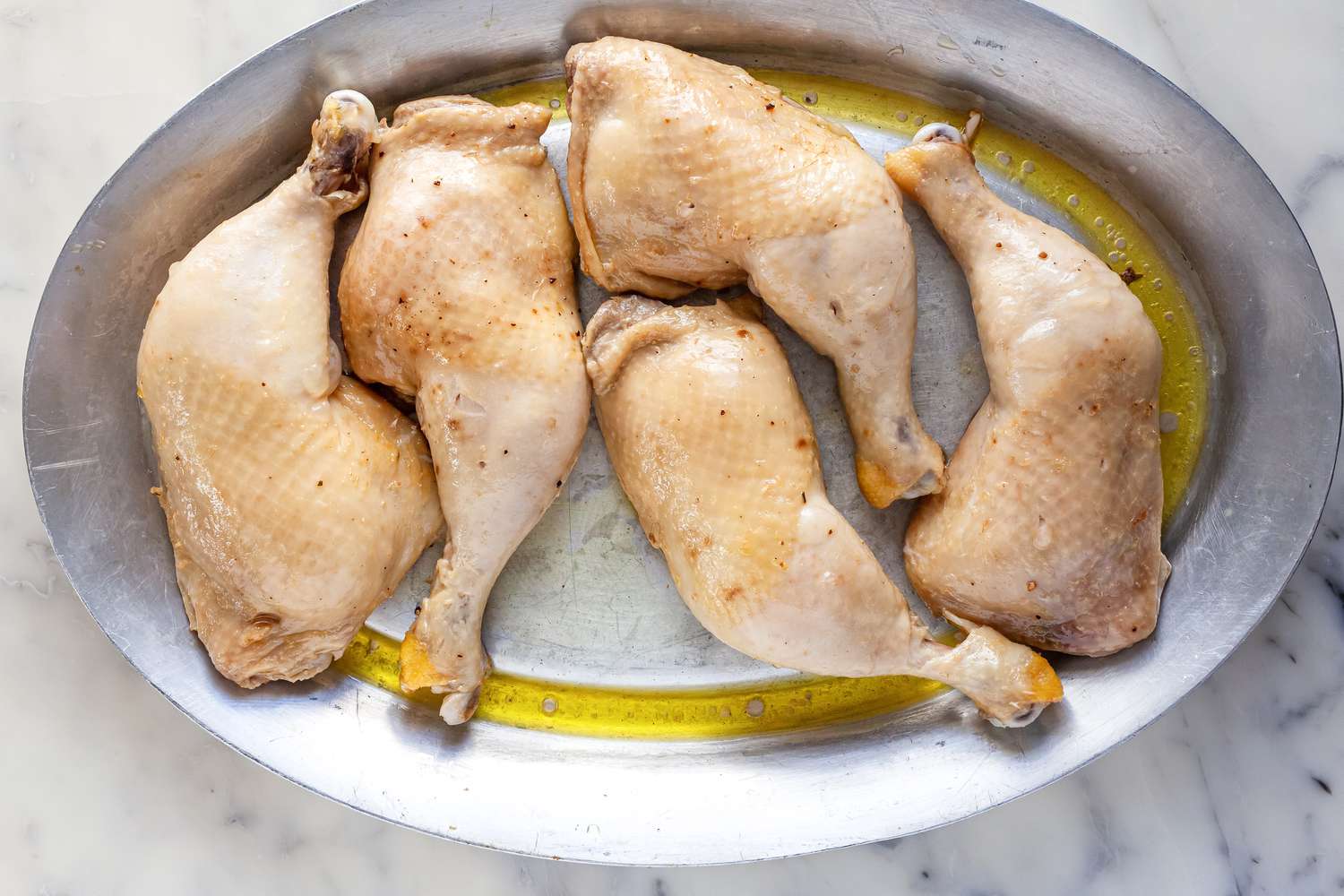 Chicken confit cooling on platter.