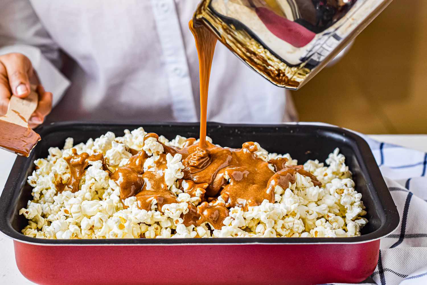 Pouring Caramel into Popcorn in Pan