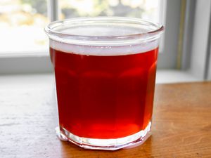 A jar of quince jelly glinting in the sun