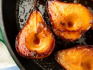 Caramelized pear halves in a skillet